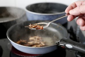 Locusts are cooked with olive oil for a discovery lunch in Brussels